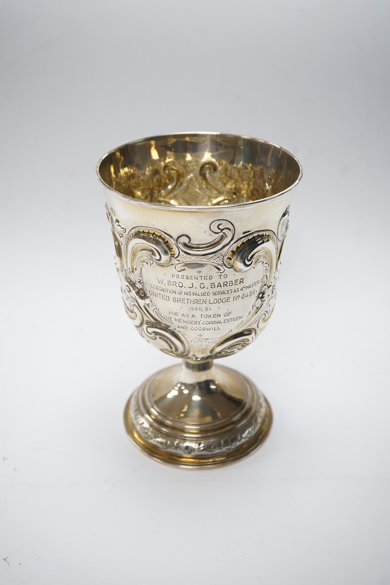 A George II silver goblet, with later embossed decoration and inscription, maker RB London, 1728, 16.6cm, 8.9oz. Condition - fair